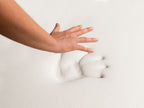 Hand lifting from the 4 lb Memory Foam Mattress Topper showing slow response pressure imprint.