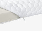 Close-up of the 4 lb Memory Foam Mattress Topper quilted cover with zipper closure.
