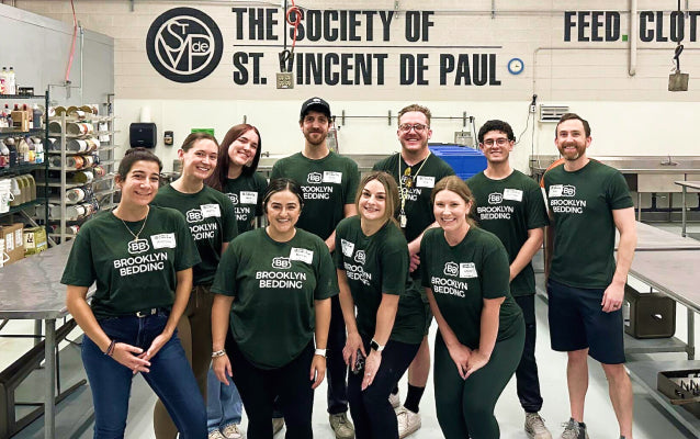 Group of people in green shirts posing for a photo at The Society of St. Vincent de Paul.