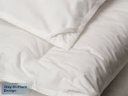 close up corner with fabric loop, Brooklyn Bedding All‑Season Alt‑Down Duvet Insert, badge reads " Stay-in-place Design"