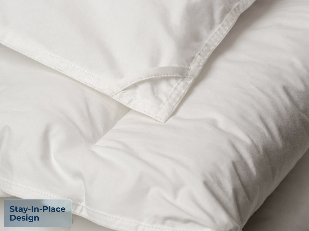 close up corner with fabric loop, Brooklyn Bedding All‑Season Alt‑Down Duvet Insert, badge reads " Stay-in-place Design"