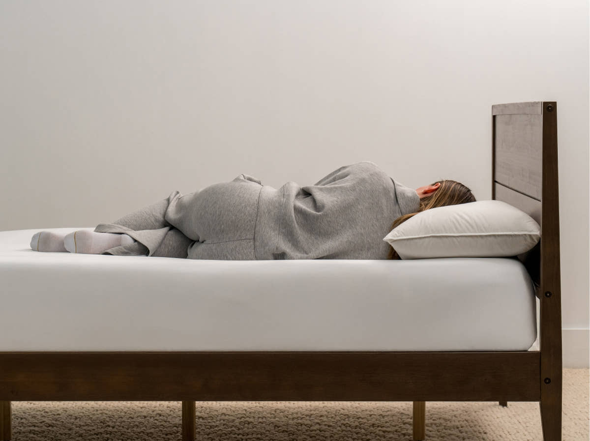 woman laying on Brooklyn Bedding Feather & Down Comfort Pillow