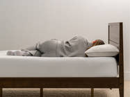 woman laying on Brooklyn Bedding Feather & Down Comfort Pillow
