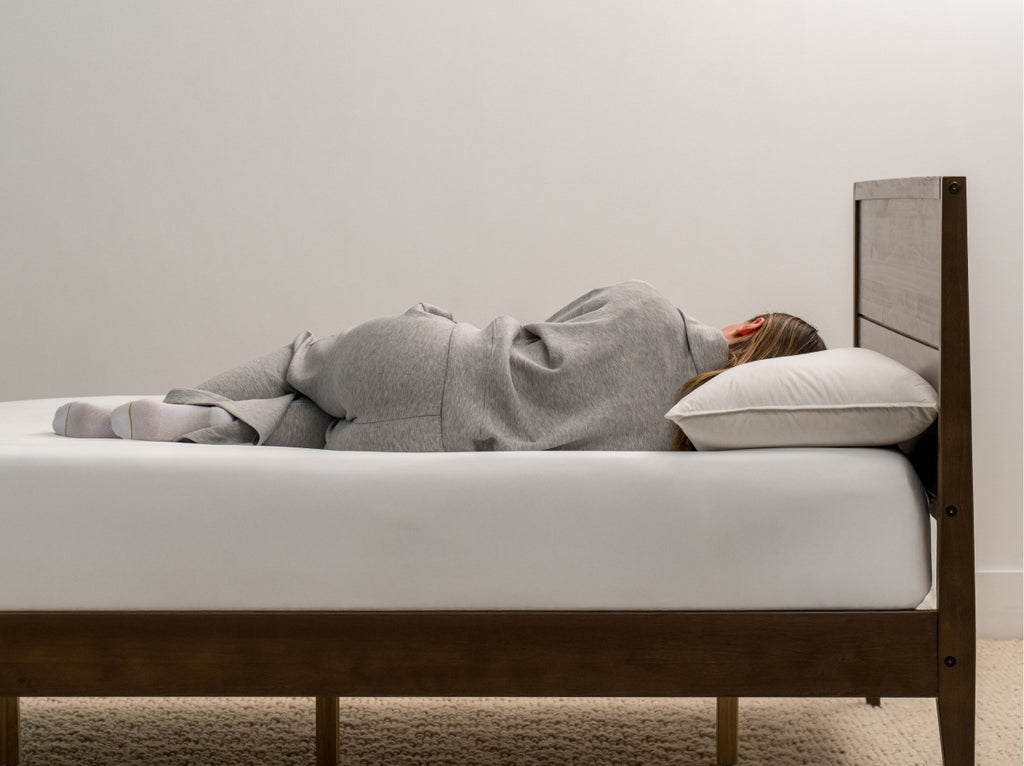 woman laying on Brooklyn Bedding Feather & Down Comfort Pillow