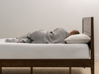 woman laying on Brooklyn Bedding Feather & Down Comfort Pillow