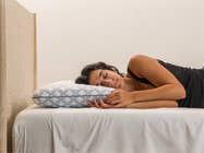 woman sleeping on low profile Brooklyn Bedding Luxury Cooling Gel Memory Foam Pillow
