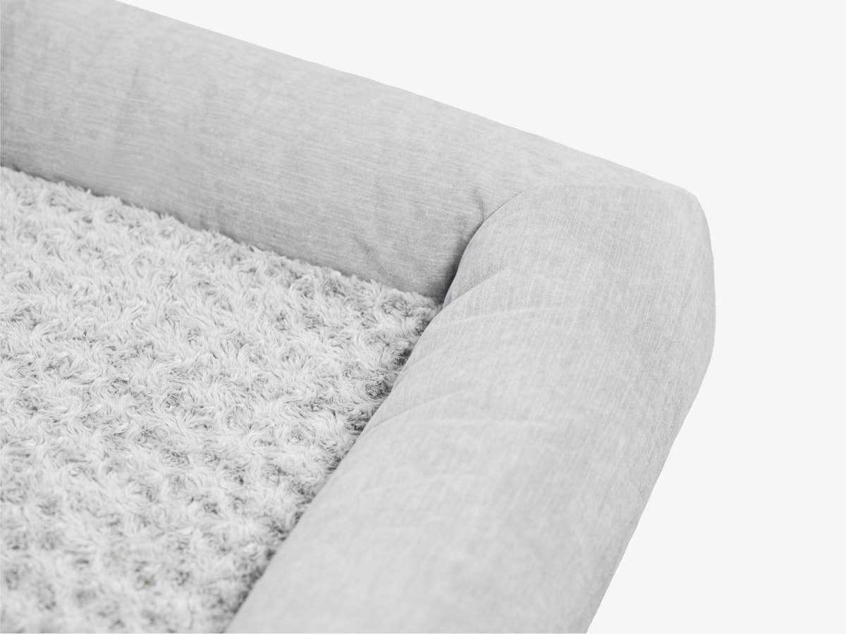 Close-up of the gray plush pet bed surface showing soft textured fabric.