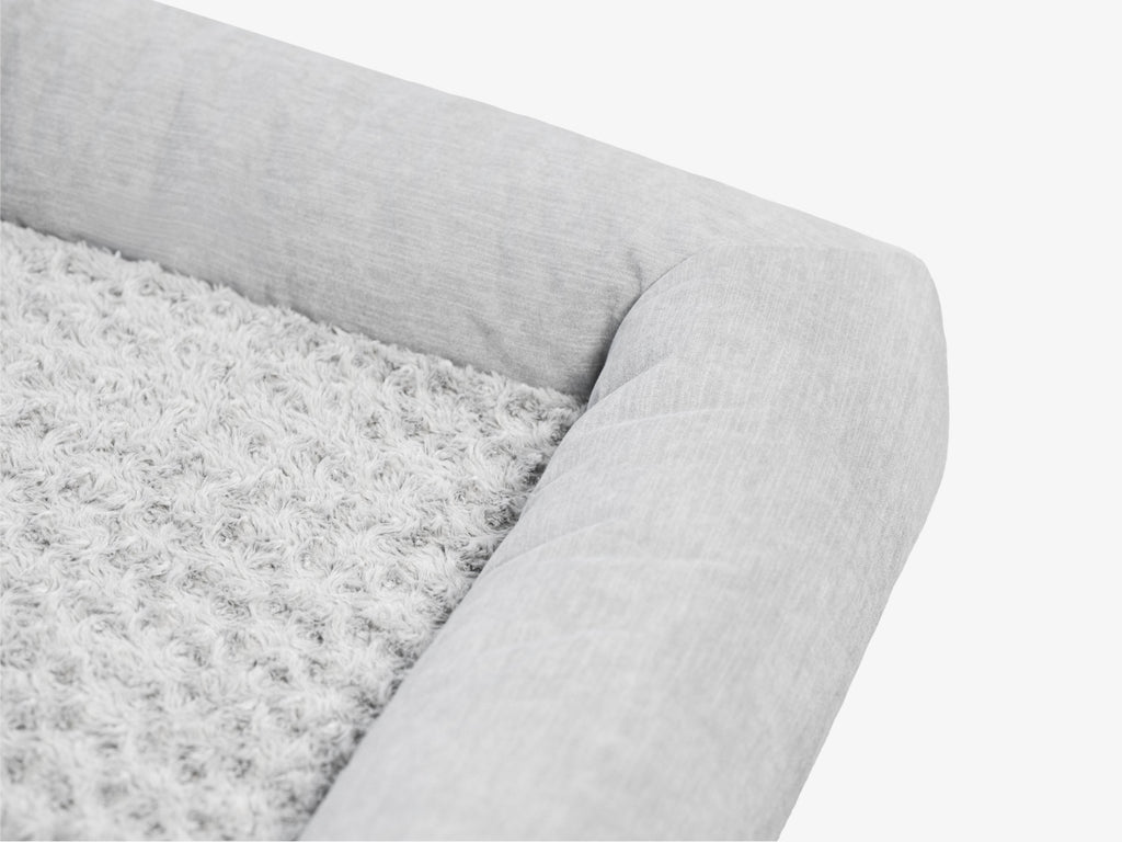 Close-up of the gray plush pet bed surface showing soft textured fabric.