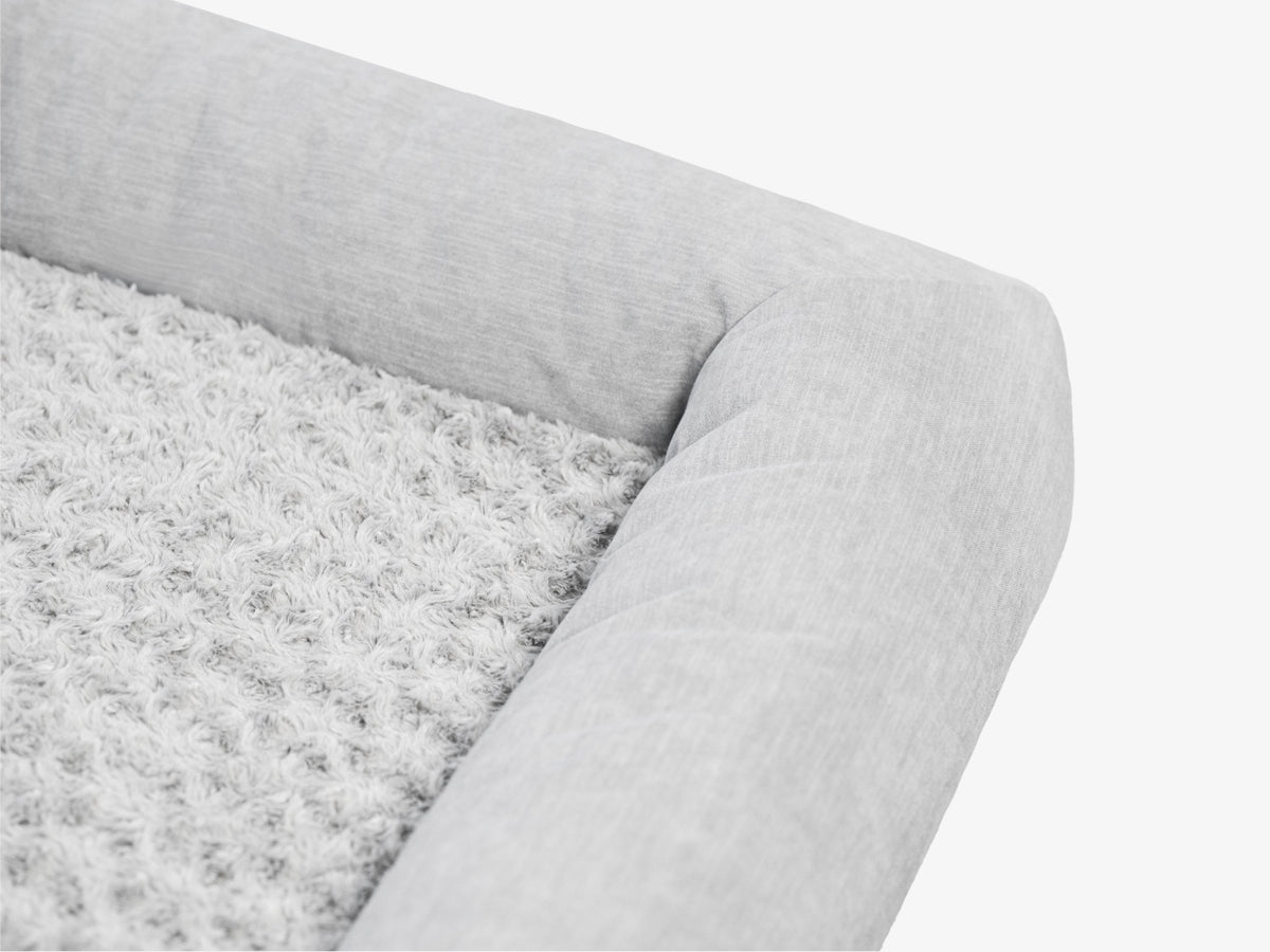 Close-up of the gray plush pet bed surface showing soft textured fabric.