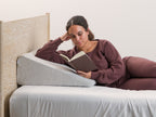 woman laying reading on Brooklyn Bedding Wedge Pillow
