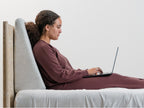 Woman in bed using Brooklyn Bedding Wedge Pillow
