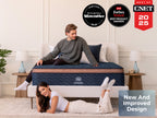 Brooklyn Bedding Aurora Luxe Cooling mattress with two people in a bedroom, with badges reading “Our Pick The New York Times Wirecutter 2025,” “2026 Forbes Vetted Best Product Awards,” “Best of CNET 2025,” and “New And Improved Design.”
