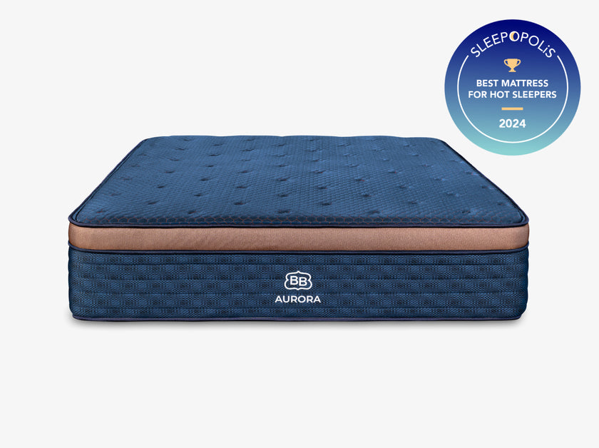 Front-facing studio image of the Brooklyn Bedding Aurora Luxe Cooling mattress in blue with copper accent band, shown on a light gray background with a Sleepopolis “Best Mattress for Hot Sleepers 2024” badge in the upper right.