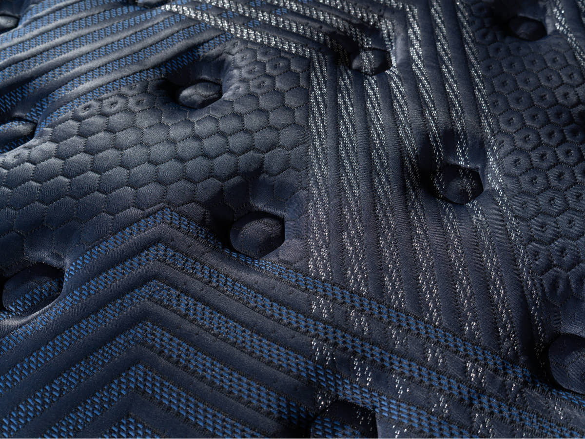 Brooklyn Bedding ThermoBalance Mattress close-up of the dark blue quilted surface with stitched geometric and hexagon patterns.