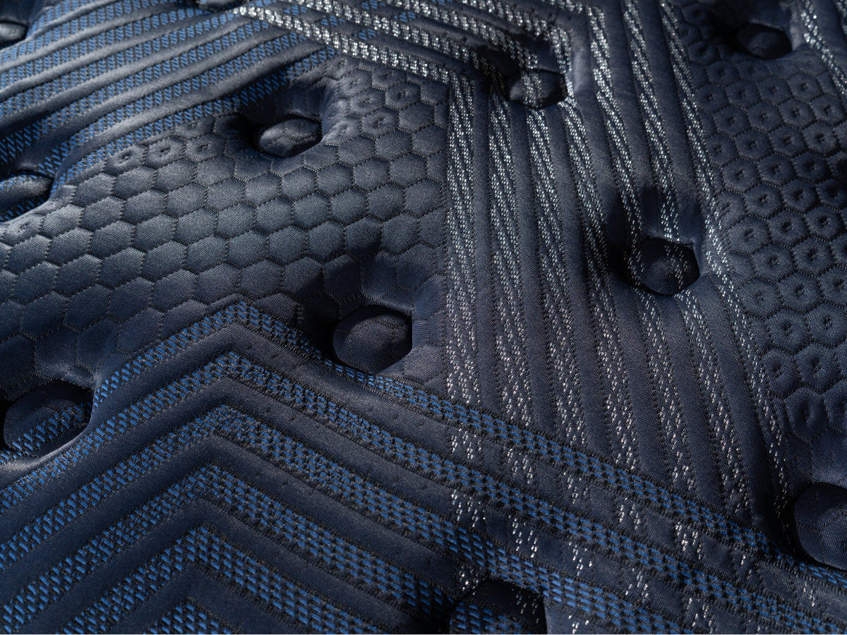 Brooklyn Bedding ThermoBalance Mattress close-up of the dark blue quilted surface with stitched geometric and hexagon patterns.