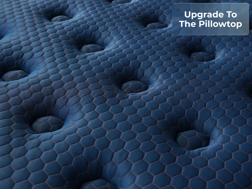 Close-up of the Brooklyn Bedding Aurora Luxe Cooling pillow top surface with a badge reading “Upgrade To The Pillowtop.”