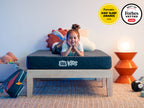 Kid laying on  Brooklyn Bedding Kids Mattress, badges read " Parents. Kids' sleep awards" and "Best of forbes vetted" 