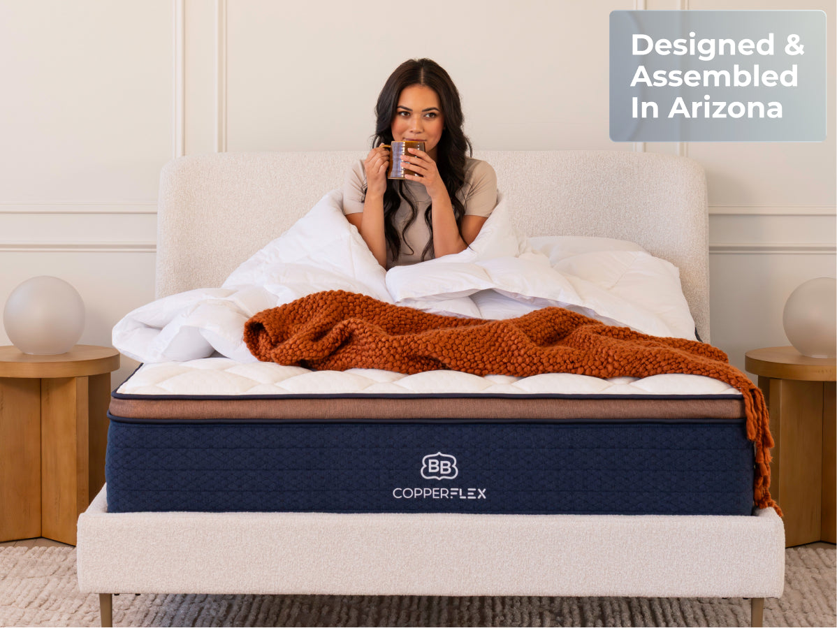 woman sitting on a  Brooklyn Bedding CopperFlex Pro Mattress with badge "Designed and Assembled in arizona"