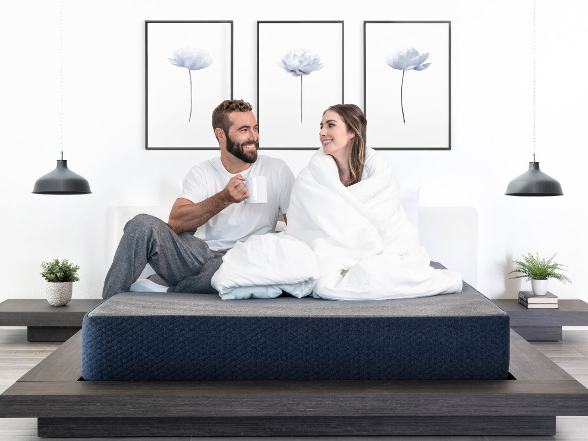 Couple sitting on  Brooklyn Bedding Dreamfoam Essential