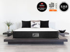 Brooklyn Bedding Plank Firm Mattress on a bed with badges reading “2026 Forbes Vetted Best Product Awards,” “The Strategist 2025,” and “WIRED Recommends 2024.”