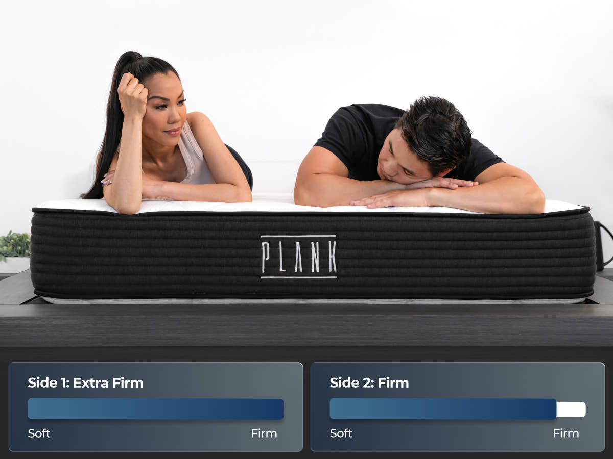 Brooklyn Bedding Plank Firm Mattress with two people lying on the bed and firmness graphics labeled “Side 1: Extra Firm” and “Side 2: Firm.”