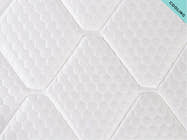 Close-up of the Brooklyn Bedding Plank Firm Mattress cooling surface with white hexagon quilting and a “Cooling” corner tag.
