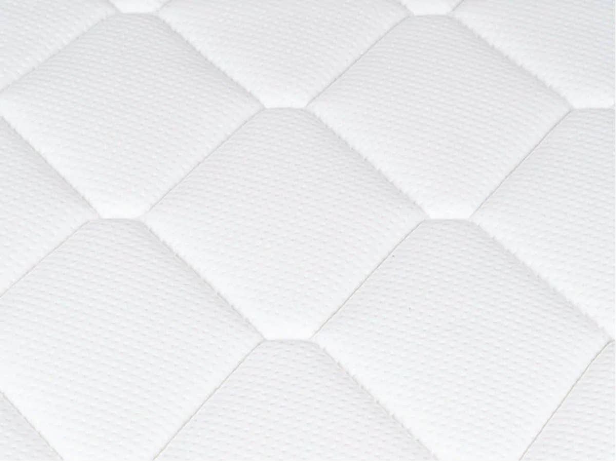 Close-up of the Brooklyn Bedding Plank Firm Mattress white quilted surface with large hexagon stitching.