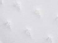 Close-up of the Brooklyn Bedding Plank Firm Mattress white quilted surface with a small textured pattern and tufted stitching.