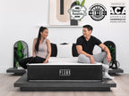 Brooklyn Bedding Plank Firm Luxe mattress with two people sitting on the bed, with badges reading “GQ Sleep Awards 2025,” “WIRED Recommends 2025,” and “Endorsed by ACA American Chiropractic Association.”
