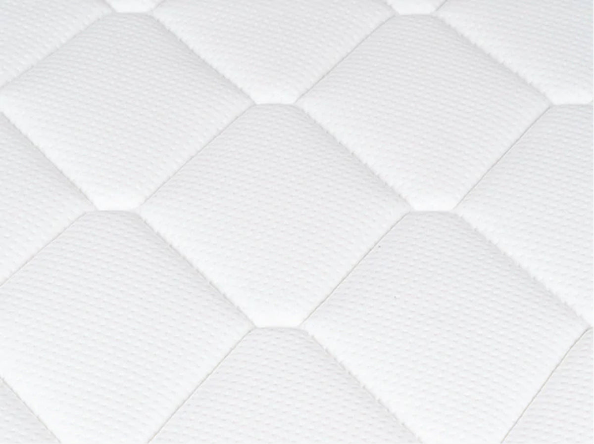 Close-up of the Brooklyn Bedding Plank Firm Luxe white quilted surface with large hexagon stitching.