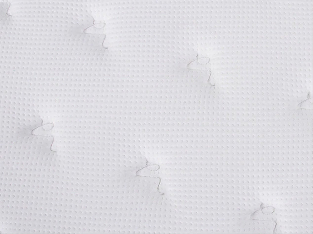 Close-up of the Brooklyn Bedding Plank Firm Luxe white quilted surface with a small textured pattern and tufted stitching.