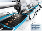 Close-up of Sedona Elite mattress panels being embroidered on a factory machine, with a badge reading “Designed & Assembled In Arizona.”