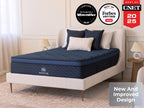Brooklyn Bedding Signature Hybrid mattress on a cream upholstered bed in a bright bedroom with award badges reading “Our Pick Wirecutter 2025,” “Best of Forbes Vetted 2024,” and “Best of CNET 2025,” plus a “New And Improved Design” callout.