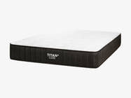 Brooklyn Bedding Titan Plus Core mattress shown at an angled three-quarter view against a light gray background, with a white quilted top and charcoal gray ribbed side panel.