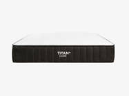 Brooklyn Bedding Titan Plus Core mattress shown in a straight-on front profile view against a light gray background, with a white quilted top and charcoal gray ribbed side panel displaying the Titan+ Core logo.