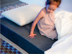  Brooklyn Bedding Kids Mattress kid feeling the fabric on mattress.