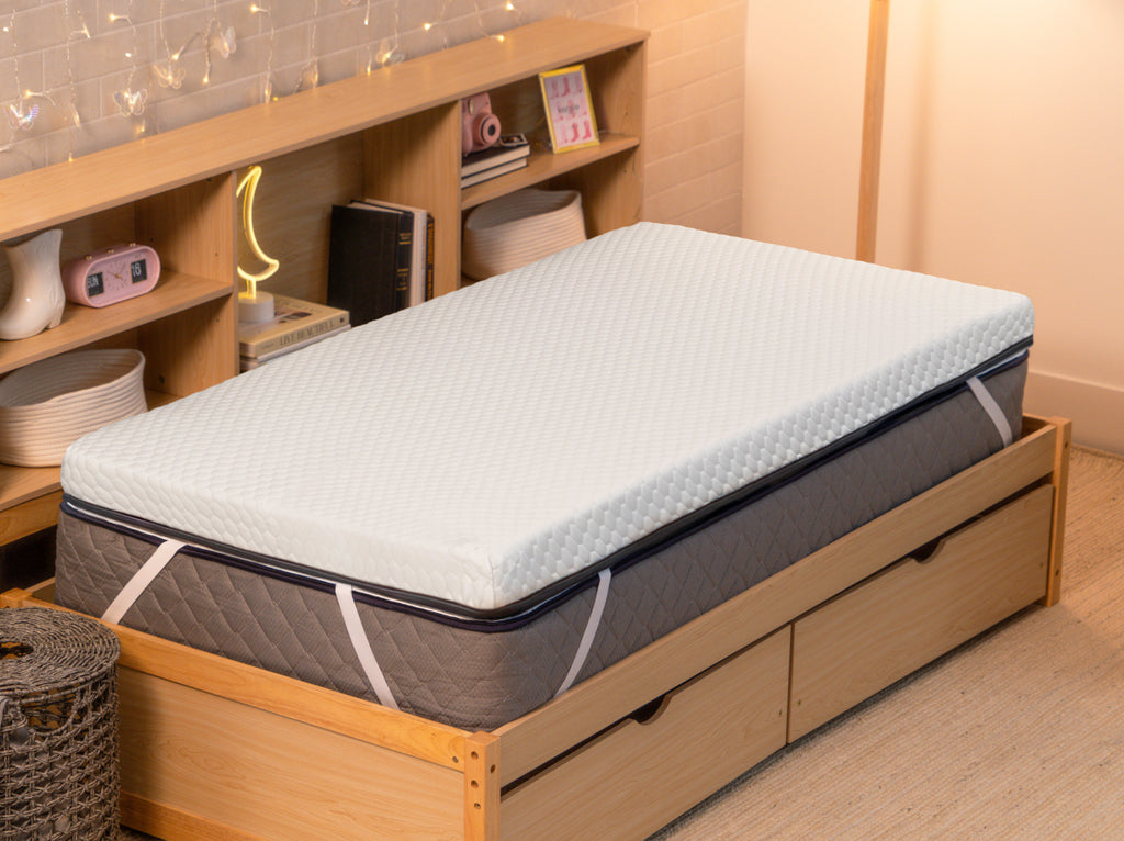 CopperFlex 301 Mattress Topper secured with elastic straps on a mattress in a bedroom setting.