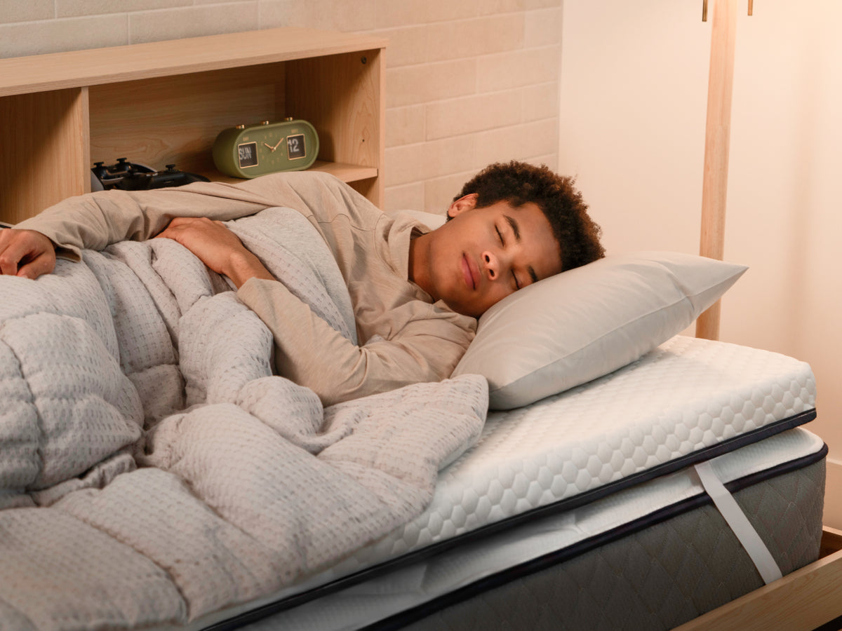 man sleeping on Brooklyn Bedding CopperFlex® 301 Mattress Topper