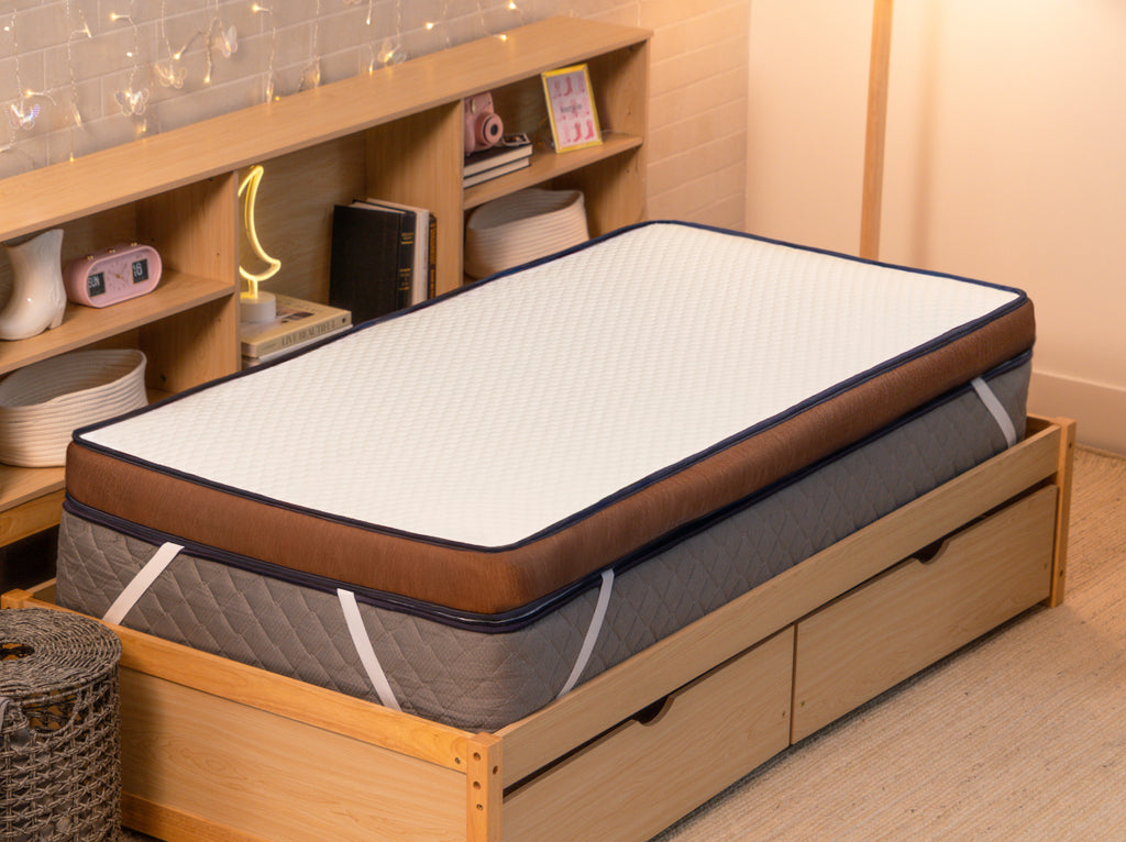 CopperFlex 401 Mattress Topper placed on a mattress in a bedroom with wood storage bed frame.