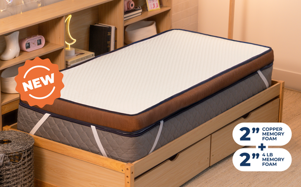 Person lying on their stomach on the CopperFlex 401 Mattress Topper on a bedroom bed.