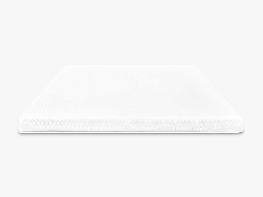 Front view of a white mattress topper with hexagon quilted cover on a neutral background.