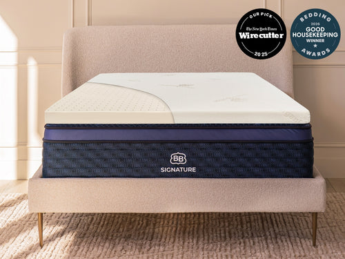  Brooklyn Bedding 3” Latex Topper on mattress. Badges read " The New York Times Wirecutter - our pick" and "bedding awards good housekeeping winner" 