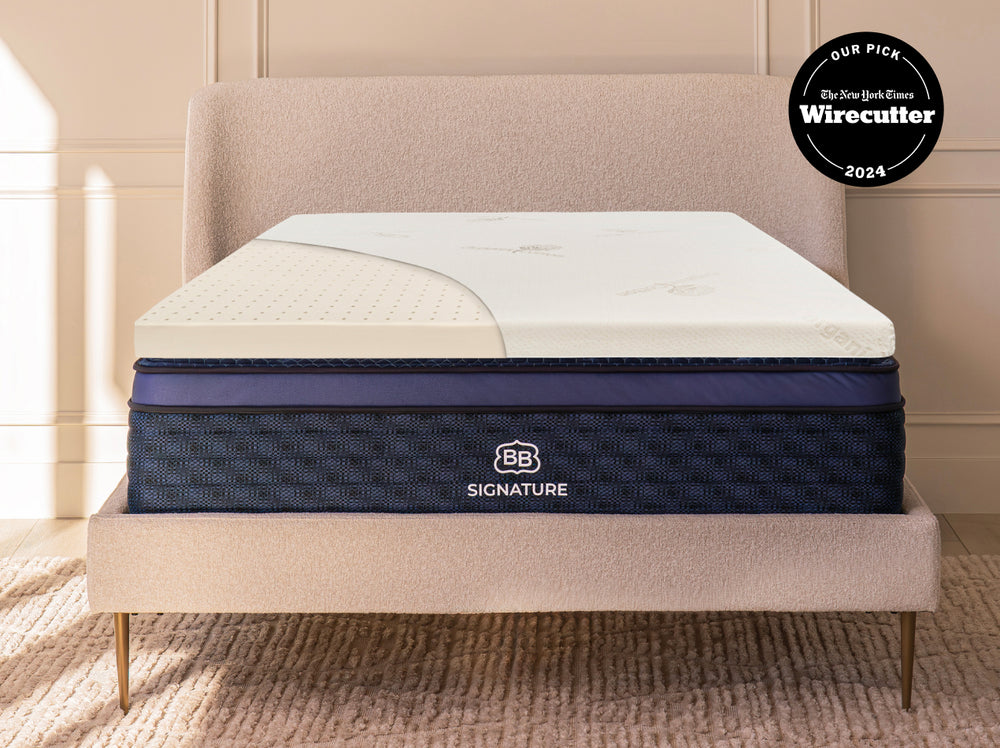 Cutaway view of Talalay latex mattress topper on a bed showing ventilated latex layer beneath the cover.