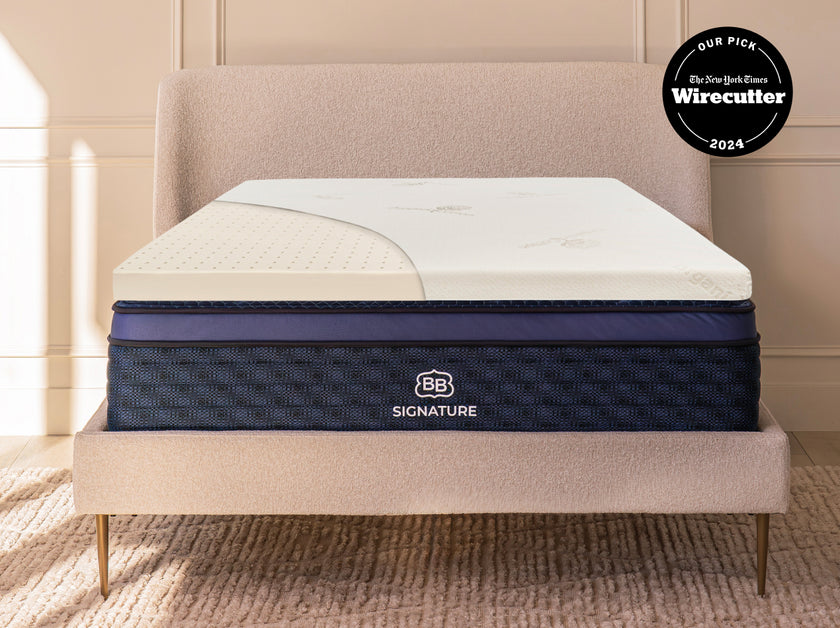 Cutaway view of Talalay latex mattress topper on a bed showing ventilated latex layer beneath the cover.