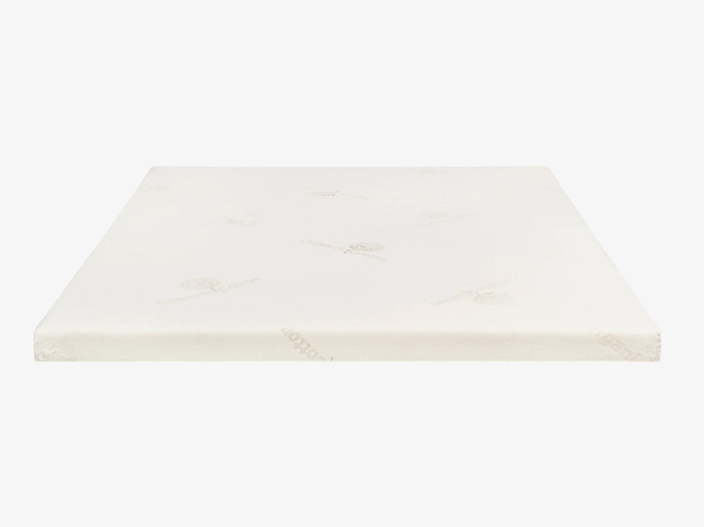 Talalay latex mattress topper encased in an organic cotton cover on a neutral background.