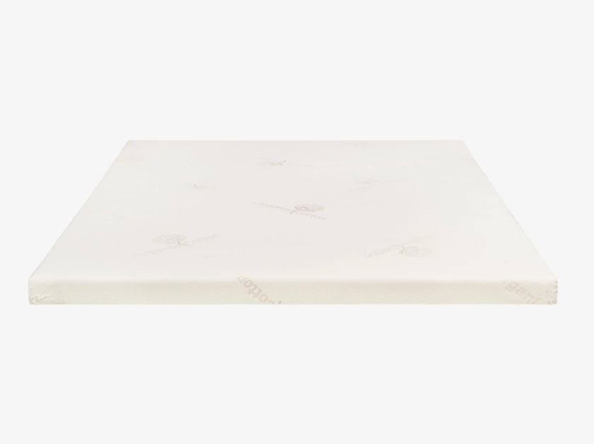 Talalay latex mattress topper encased in an organic cotton cover on a neutral background.