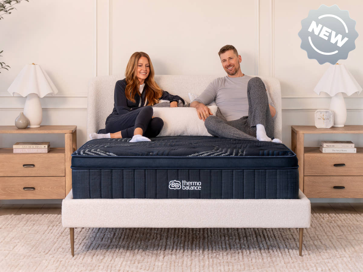 Brooklyn Bedding ThermoBalance Mattress with two people sitting on the bed, with a badge reading “NEW.”