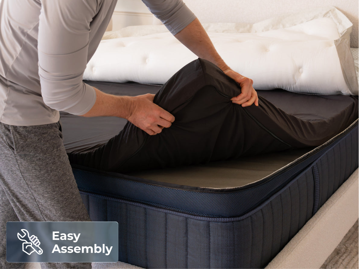 Brooklyn Bedding ThermoBalance LX Elite Mattress with a person placing the cover over the mattress, with a badge reading “Easy Assembly.”