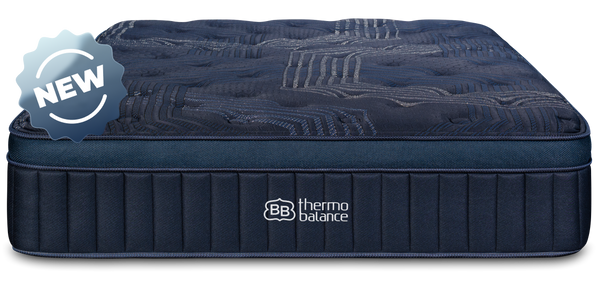 Couple sitting on a bed with a mattress labeled  Brooklyn Bedding Thermobalance in a bedroom setting.