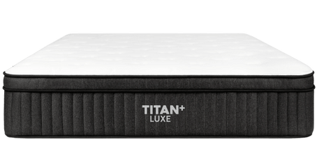 A modern bedroom with a Titan Elite mattress on an adjustable base. Text highlights benefits: eases snoring, zero-gravity position, and improved circulation.